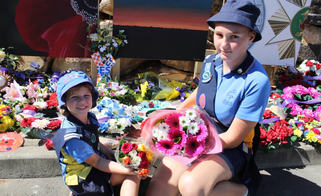 Browns Plains Girl Guides members Ashleigh Walker and Jessica Da Rosa laid flowers at the Greenbank RSL sub-branch's Anzac Day service.