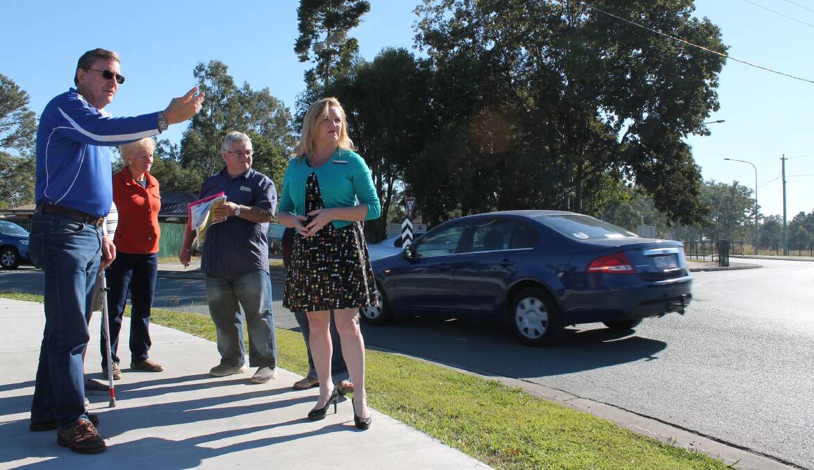 TRAFFIC CONCERNS: Paul Casbolt, of Buccan (left) speaks with Logan City Council Division 4 councillor Laurie Koranski and other residents at Logan Village's North Street Roundabout. Photo: Michael Burge