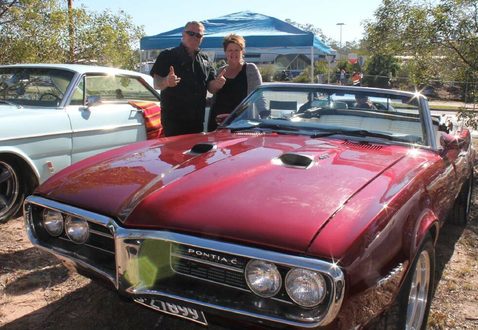 VEHICLES: Roger and Mary Kurinnyi, of Jimboomba, with their '68 Pontiac Firebird at last years event. Photo: Georgina Bayly