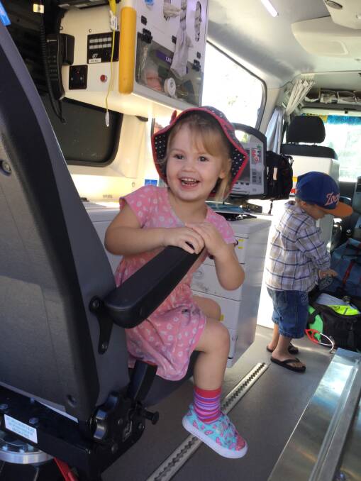 EMERGENCY SERVICES: Reaghan Dreyer had a seat in the ambulance that visited Goodstart at Flagstone. Photo: Supplied