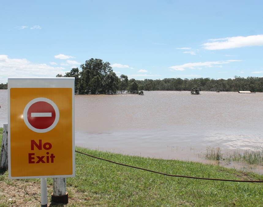 WATER: The view towards Camp Cable Road from Coles Express in Jimboomba on Friday, when the water continued to rise. Photo: Georgina Bayly