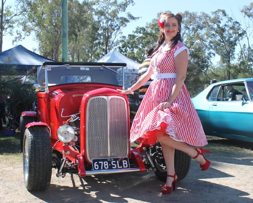 PIN UP: Louise Davis, of Jimboomba, shows off her style with a '32 Ford Roadster just before the rockabilly fashion parade. Photo: Georgina Bayly