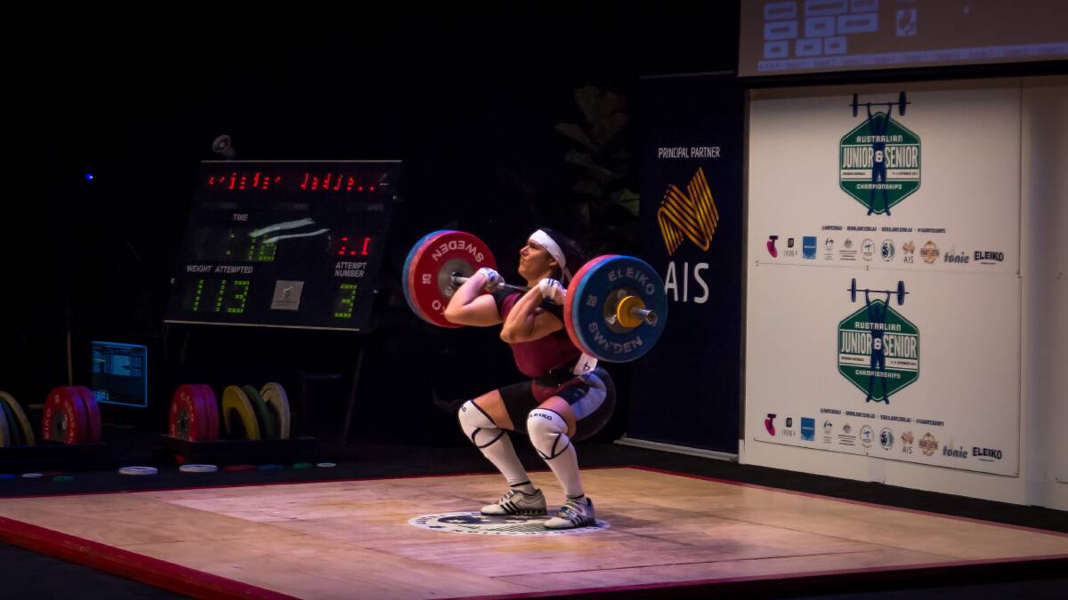 PUSH IT: Kristen Wadell during her 113kg clean and jerk lift at the Australian Weightlifting Championships. Photo: Field Media.