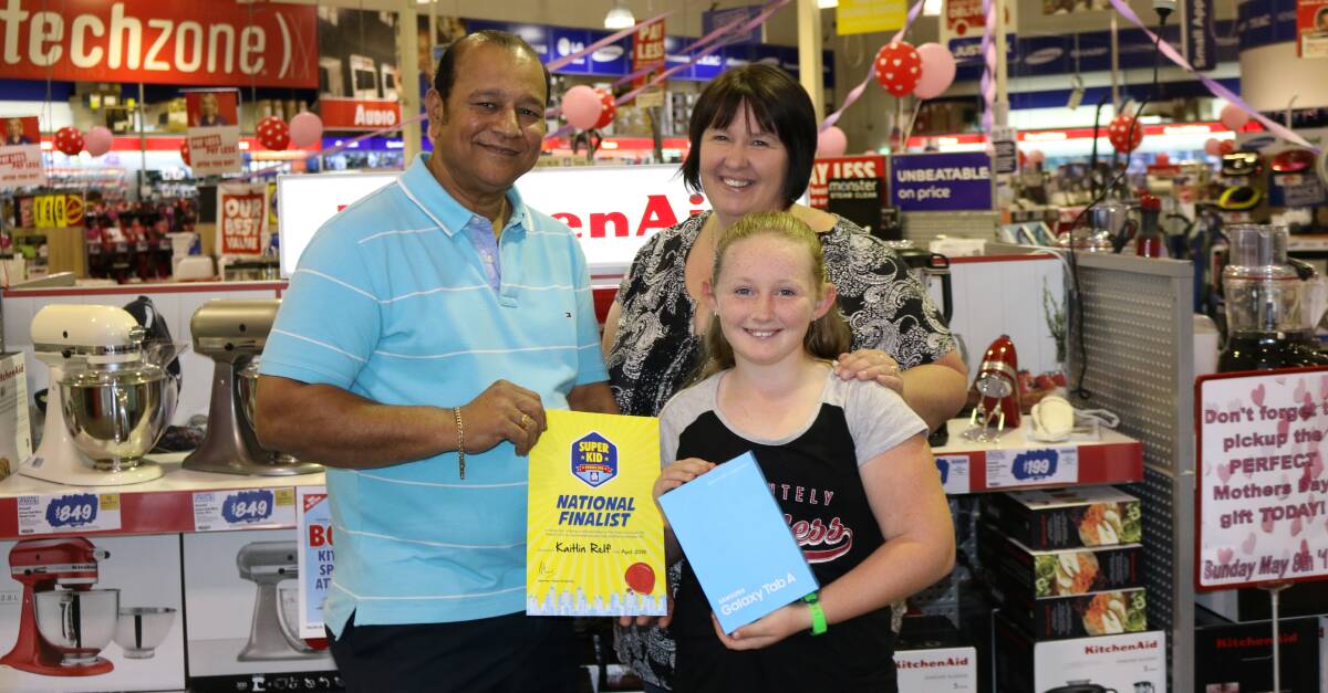BATON: Kaitlin Relf, pictured with mother Andrea Relf and Browns Plains business proprietor Russell Daniells after her nomination in the super kid finals last year.