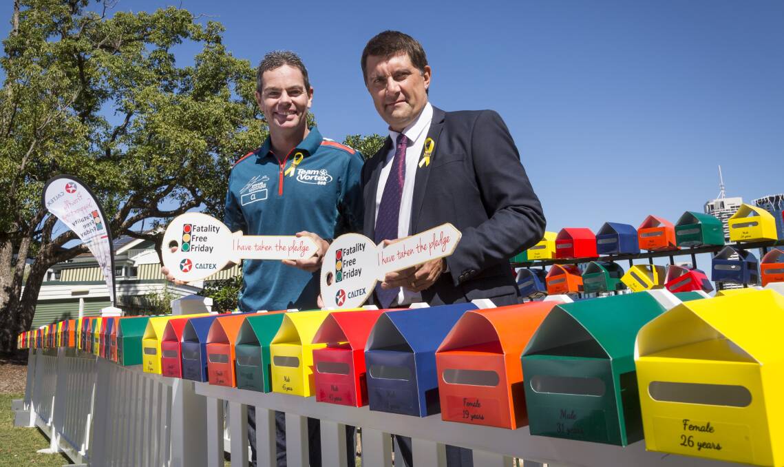 V8 Supercar driver Craig Lowndes and Australian Road Safety Foundation CEO Russell White among a mailbox installation remembering the hundreds of Queenslanders who will never make it home again. Photo: Supplied