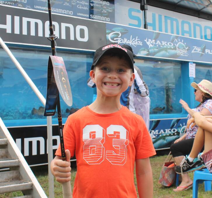 FISHERMAN: Hunter McNeill, 6, was the very happy recipient of a fishing rod after taking part in the demonstration at the Shimano exhibit on Saturday morning. Photo: Georgina Bayly
