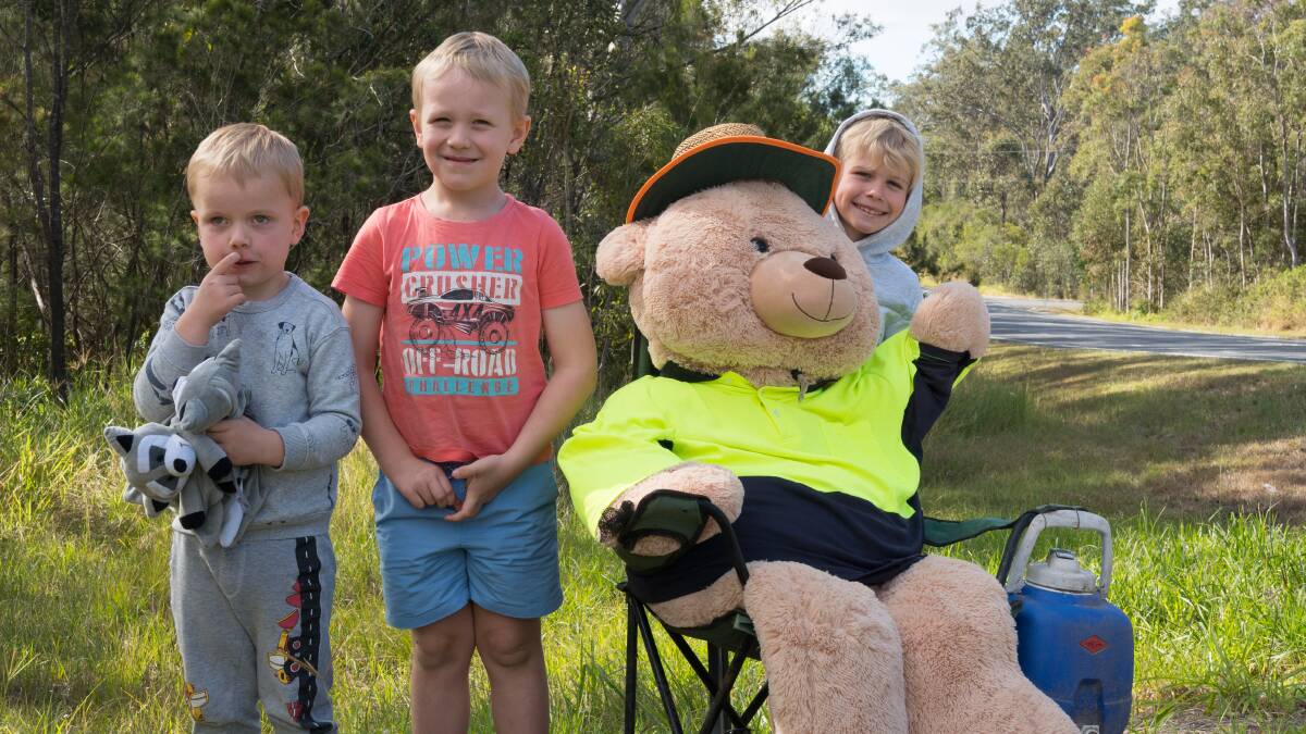 TEDDY BEAR'S PICNIC: Local youngsters Zane, Macauley and Jedd welcome the teddy bear to its new home on Camp Cable Road. Picture: Joe Colbrook.