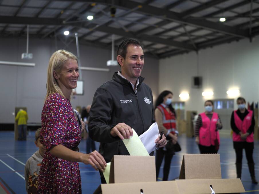 ELECTION DAY: Rankin MP Jim Chalmers (centre) and wife Laura cast their votes. Picture: Joe Colbrook.