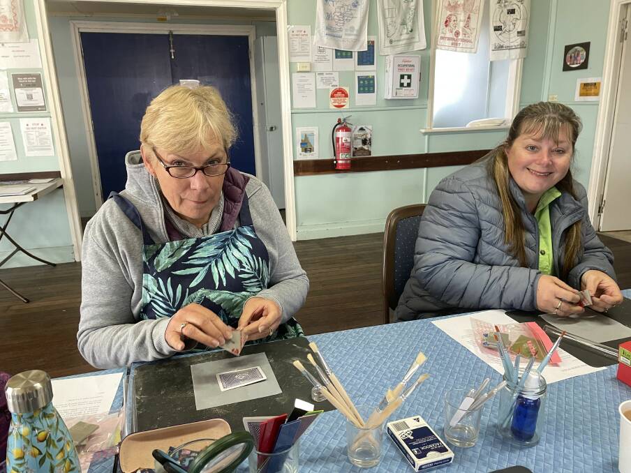 Jill Holmes and Annette Muchow hard at work making their charms. Picture by Larraine Sathicq.