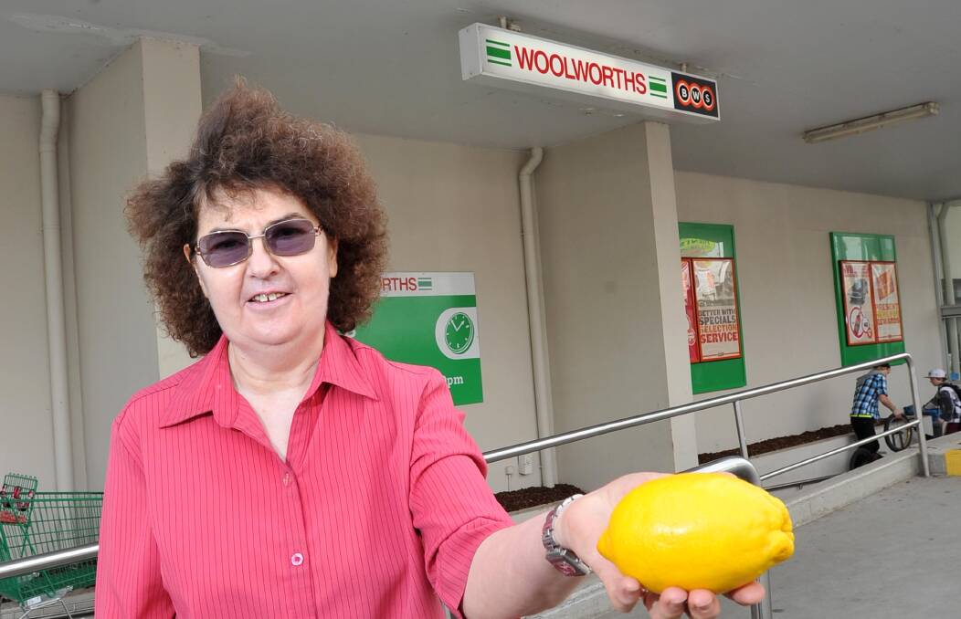 Coles and Woolworths among the "lemons" given Shonky Awards by Choice. Joy Stein pays $8 for a big lemon at Woolworths. File picture