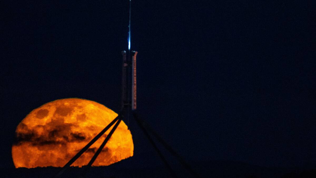 A supermoon rises above Parliament House in Canberra earlier in August. Picture by Canberra Times/ Gary Ramage