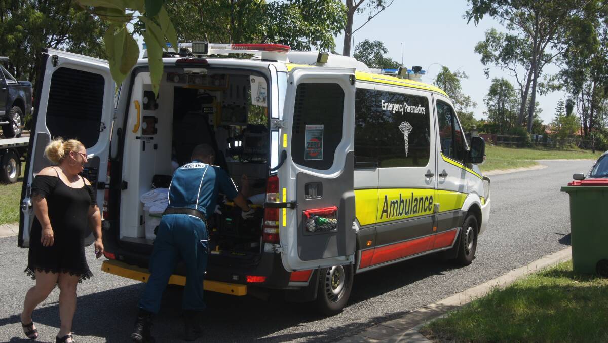 LONG WAIT: Paramedics attend to a 67-year-old Flagstone man. Photo: Jacob Wilson