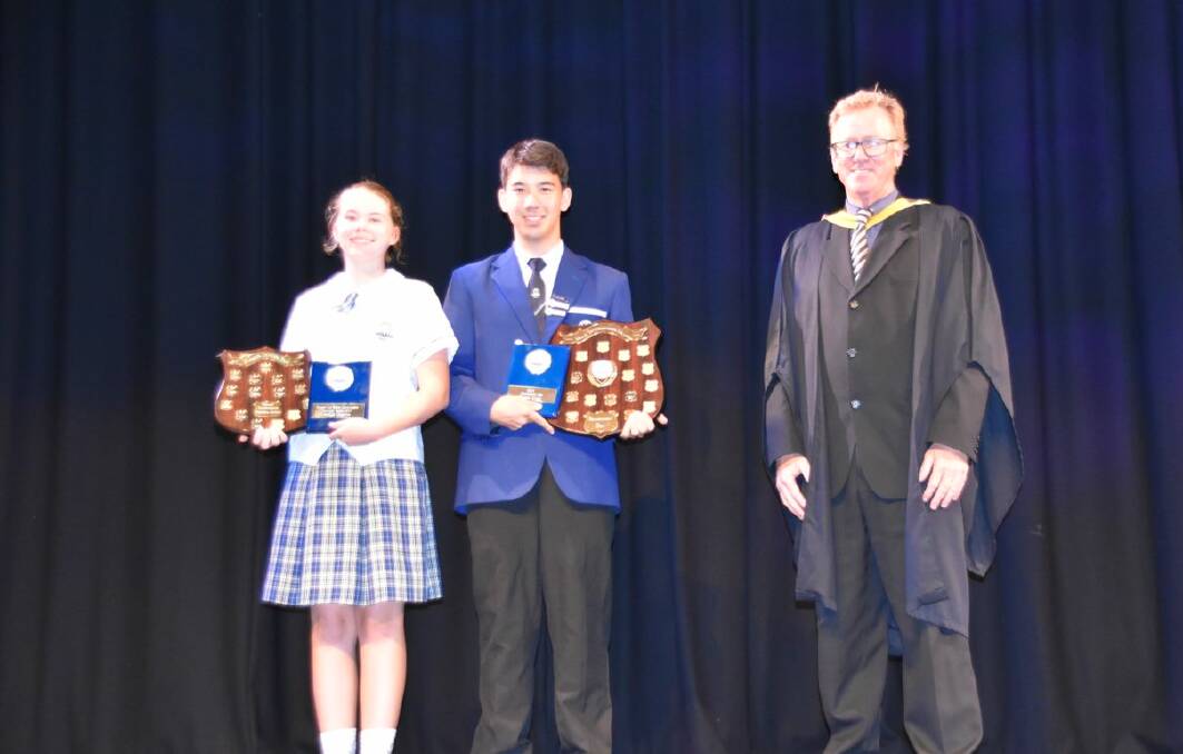 DUX WINNERS: Primary School dux Gaelle Degryse, Secondary school dux Eugene Clark and principal Kevin Lynch.