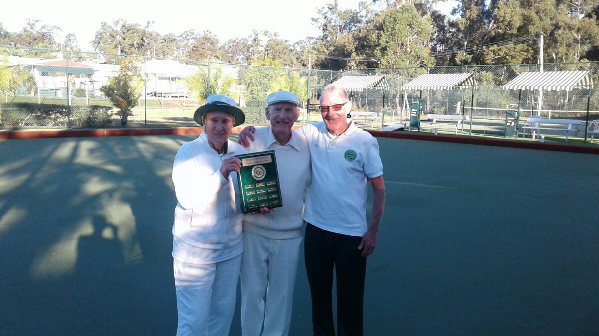 WINNERS: Mixed pairs bowling champions Pauline Young and Jim Clark with Greenbank Gardens Bowls Club president Len Holden.