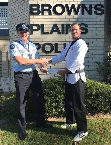 PARTNERS: Browns Plains police Senior Sergeant Michael Leafe presented Swordsmen Martial Arts School instructor Simon Egan with a $250 donation. Photo: Queensland Police Service