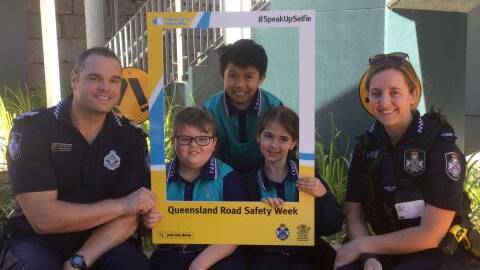 Jimboomba police acting sergeant Hayden Wilson and constable Bernie Auld with year two Yarrabilba State School students. Photo: Queensland Police Service