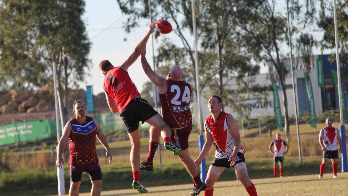 IN THE AIR: Jimboomba Redbacks Masters players Jonathon Bax and Nathan Flack worked hard on the field. Photo: Supplied