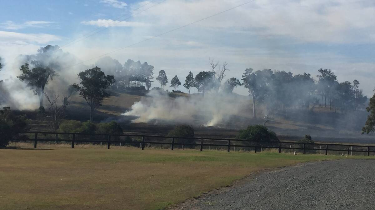 Smoke surrounded a Mundoolun paddock fire this afternoon. Photo: Jacob Wilson