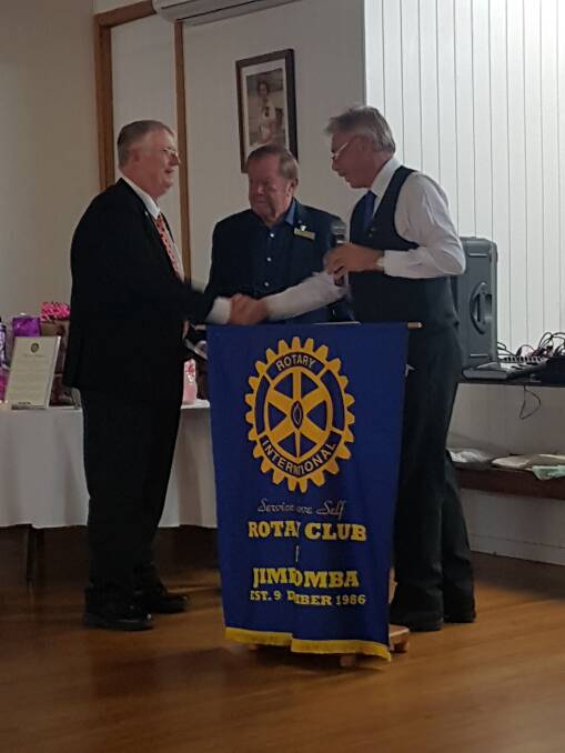 ROTARIAN: David Kenny received the Paul Harris award from District Governor Terry Brown and Mal Strachan