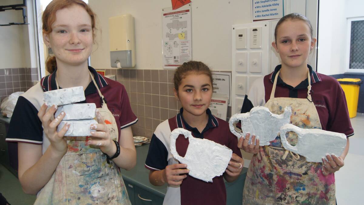 CREATIVE: Emmaus College students Ella O'Neil, Annaliese Price and Alexandra Brazel have been making props for the Beauty and the Beast musical. Photo: Jacob Wilson
