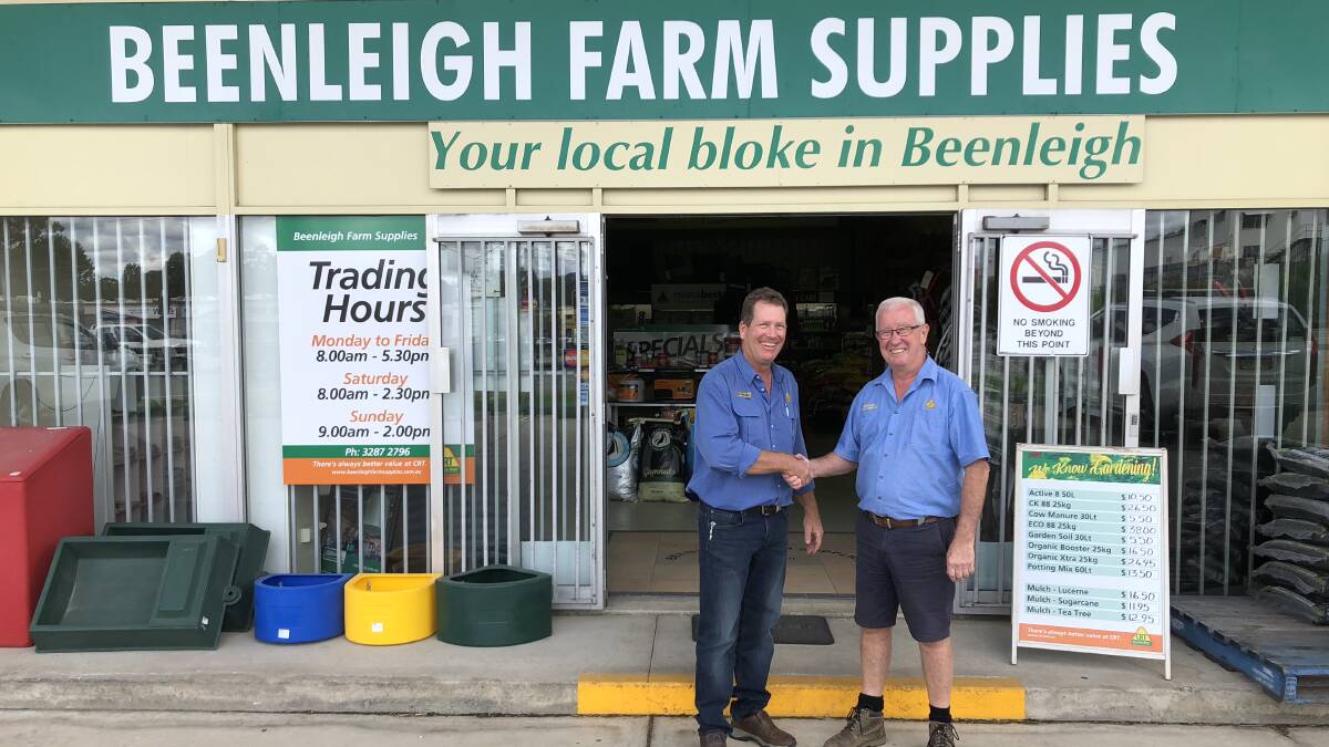 SOLD: Farmcraft general manager Alistair Ross and outgoing Beenleigh Farm Supplies co-owner Barry Owens shake hands ahead of the business sale on July 1. Photo: Supplied