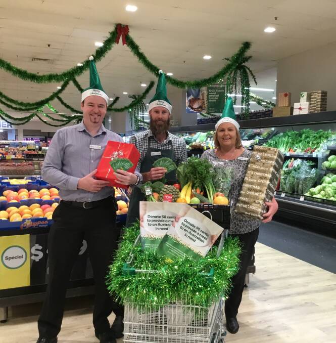 CHRISTMAS SPIRIT: Browns Plains Woolworths assistant store manager Steve Lewis, produce team leader Brett Hardy and store manager Vivienne Schreiber. Photo: Supplied