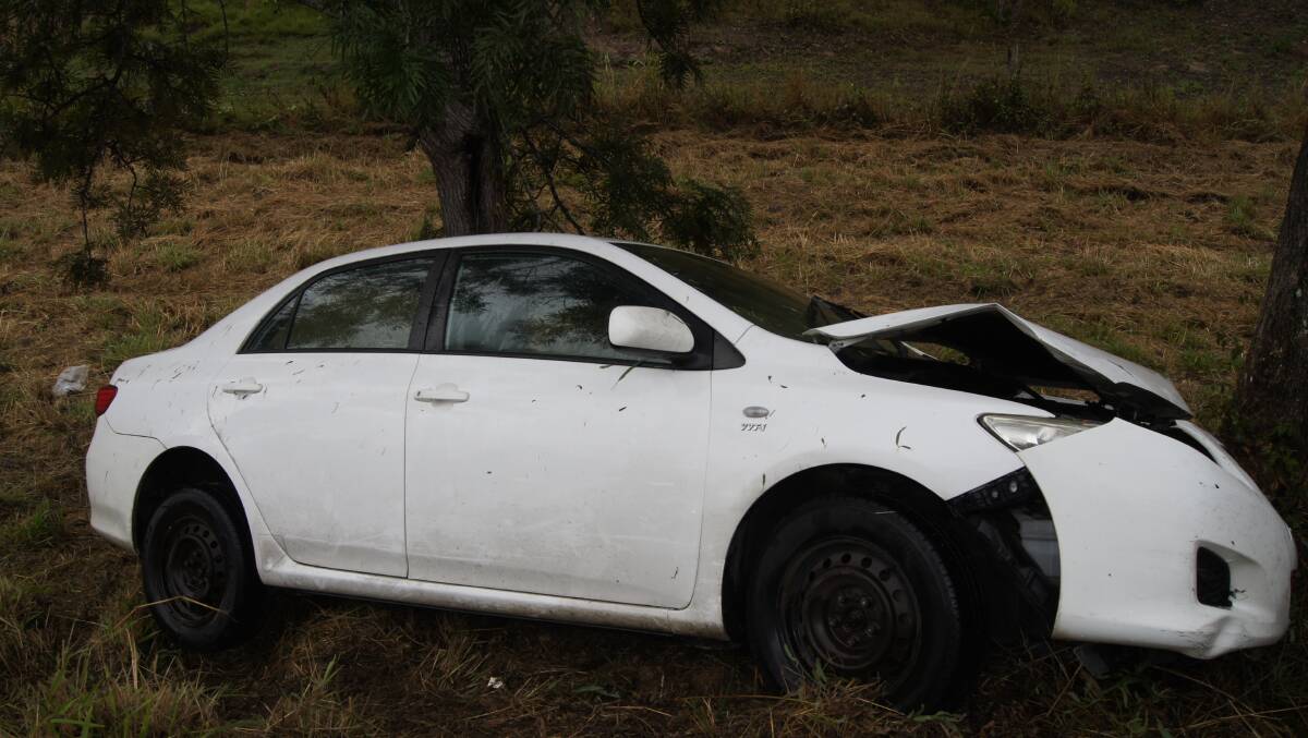 CRASH: The Toyota Corolla hit a tree on the Mount Lindesay highway. Photo: Jacob Wilson