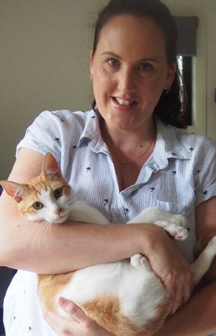 FRIENDLY CAT: Waterford resident Julia Cooper with her adopted pet Olly. Photo: Logan Council