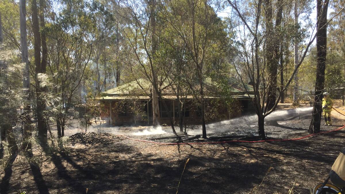 CONTAINED: Firefighters contained as blaze spreading to a Swan Road property this afternoon. Photo: Robert Bloss