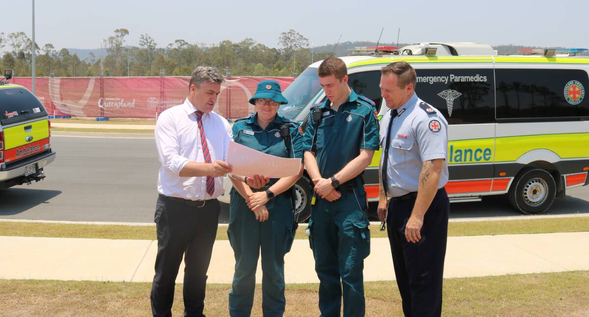 HEALTH: Logan MP Linus Power with paramedics looking forward to the completion of a $4.3 million ambulance station expected in 2021.