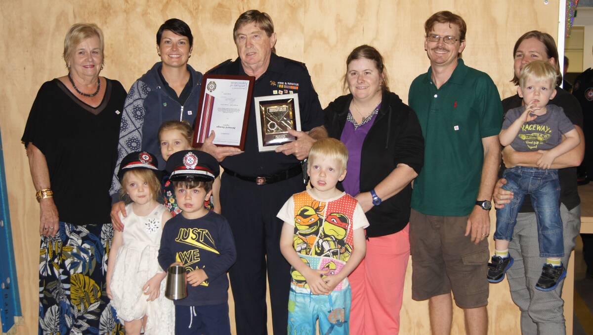 HONOURED: Retiring QFES Jimboomba station captain Bernie Savage with his family at his retirement party. Photo: Jacob Wilson