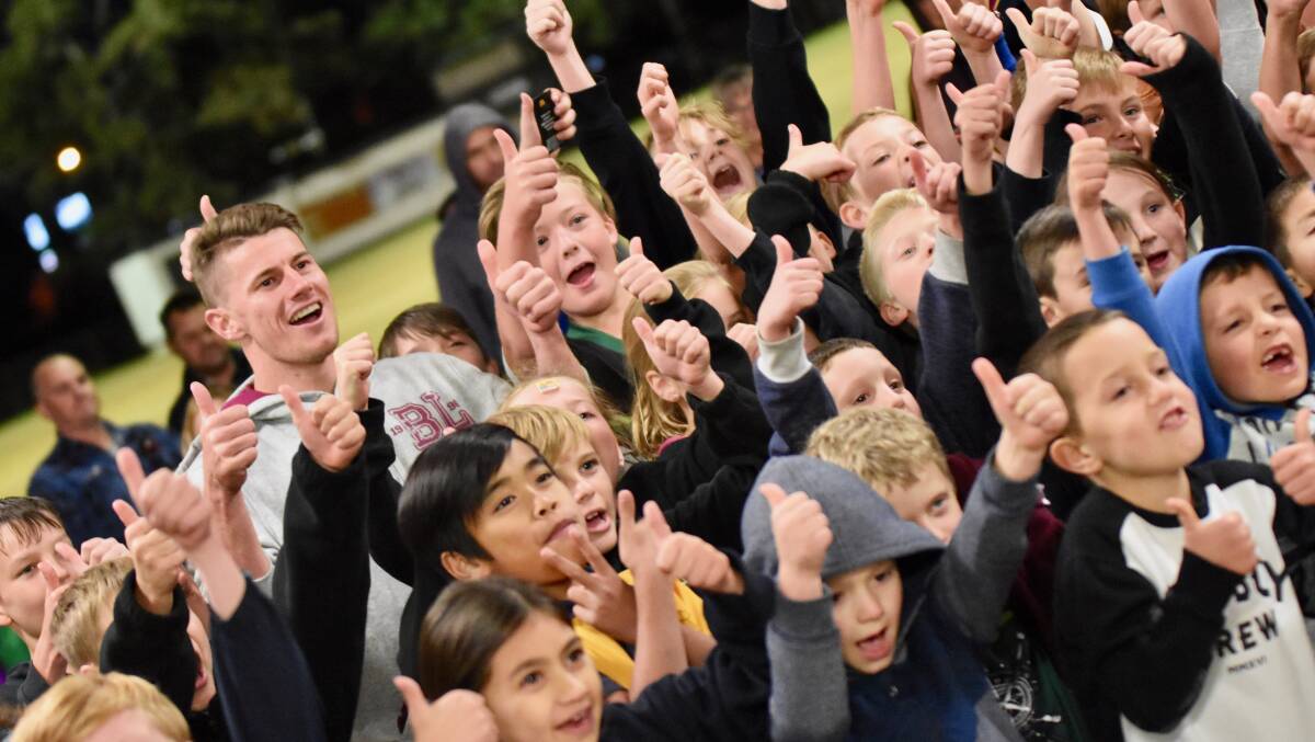 EXCITEMENT: Brisbane Lions players Dayne Zorko and Ryan Lester got a rockstar welcome from the Park Ridge Pirates on June 4. Photo: Kelli Greene