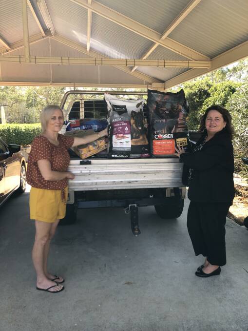 DONATION DRIVE: New Beith resident Cheryl Ueberdiek with Kathleen de Leon in support of a campaign to deliver dog food to drought affected communities in Queensland. 