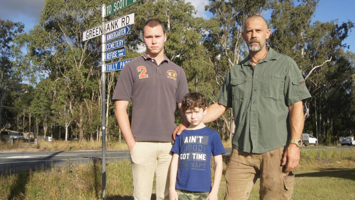 KILLER ROAD: Tyler Day, Jan Renner and Kai Renner called for action on the North Maclean stretch of the Mount Lindesay Highway in June last year. Photo: Jacob Wilson 