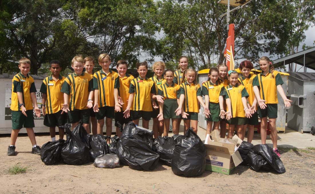 CLEAN UP: Jimboomba State School students took to the oval on Friday mornign to pick up thousands of pieces of rubbish. Photo: Jacob Wilson
