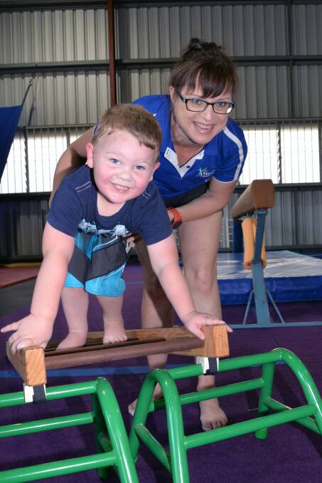 KEEPING FIT: Dexter Grant with FunFit Gymnastics coach Helen Page. 