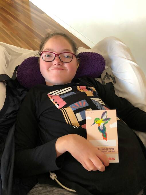 INSPIRING: Mikaela Norris helped support Hummingbird House by using a painbursh in her mouth to decorate a donation card for Coles.
