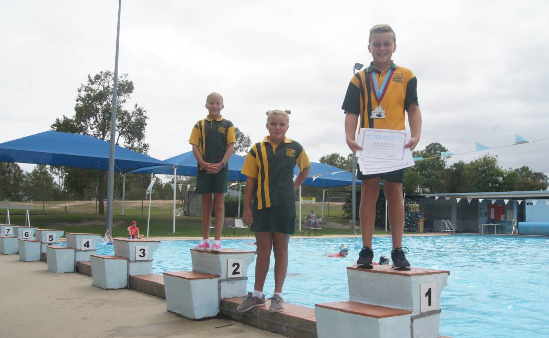 GLORY: Jimboomba State School students Zarlee Browne, Isabella Gonzalez and Ryan Sutcliffe will comepte at the South Coast Regional Swimming Championships on February 26. Photo: Jacob Wilson 