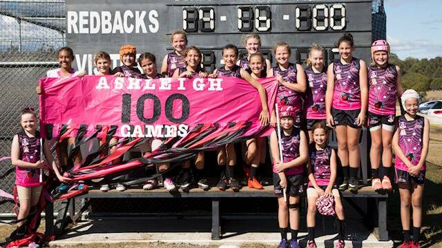 MILESTONE: The Jimboomba Redbacks celebrated under 13 girls co-captain Ashleigh Hodges in their game against Coorparoo. Photo: Supplied