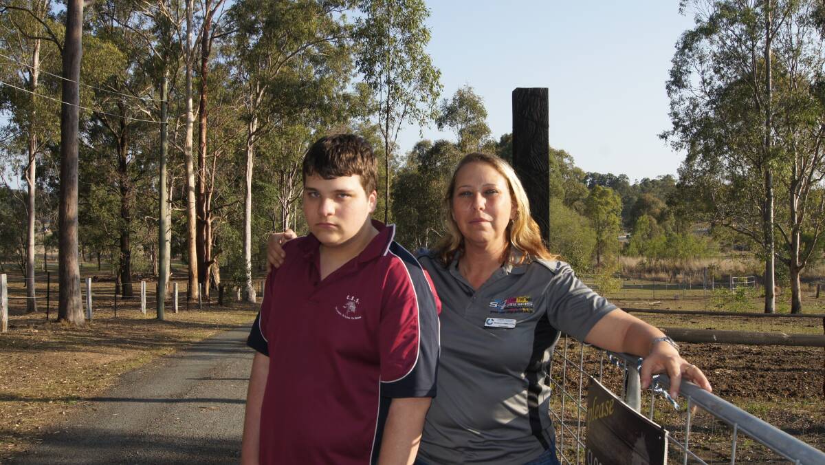 DISGUSTED: Woodhill resident Monica Hambleton with her son Andrew Crane on their Woodhill property near the approved development site for a truck stop petrol station. Photo: Jacob Wilson