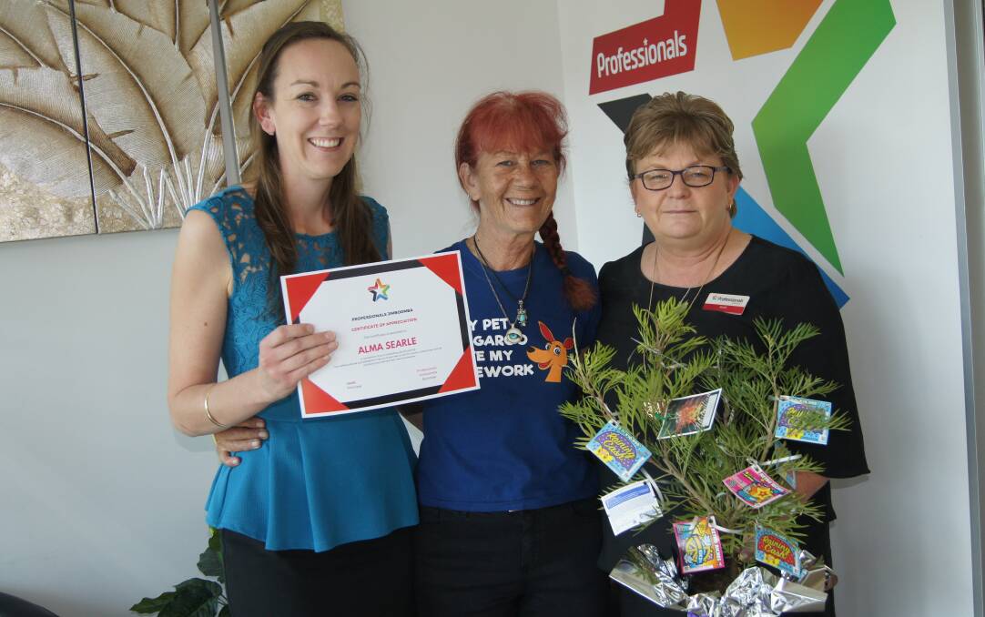 APPRECIATION:  Wildlife carer Alma Searle was awarded with an appreciation certificate with Megan Behn (left) and Heidi Taylor (right) from Professionals Jimboomba. Photo: Jacob Wilson