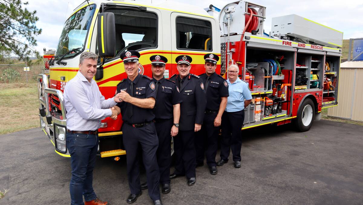 Logan MP Linus Power with Logan Village firefighters on Saturday afternoon.