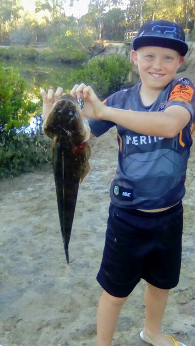 FLAT OUT: Ten-year-old Zachary Baker happy with his catch of a 62cm flathead from Eprapah Creek. Bigger fish are starting to appear in local waters.