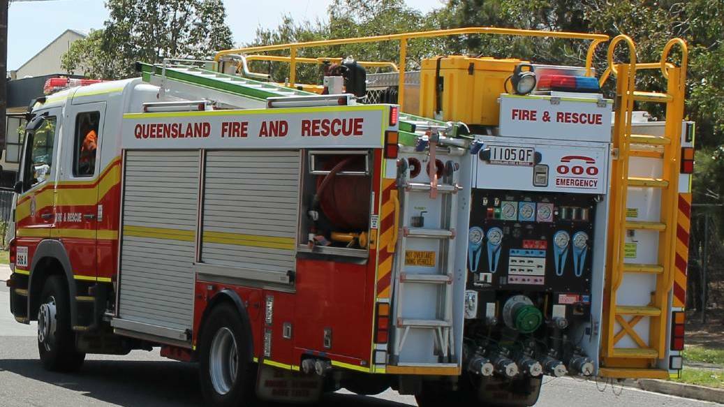 MISSION: Queensland Fire and Emergency Services personnel, including technical rescue specialists are working to rescue a woman who is stuck up a tree.