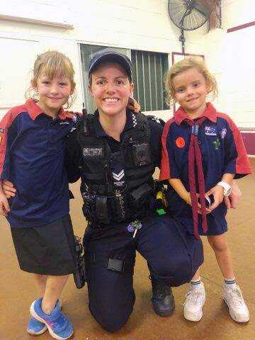 BUILDING TRUST: Police officer from the Logan District Crime Prevention Squad rubs shoulders with the Marsden Scouts.