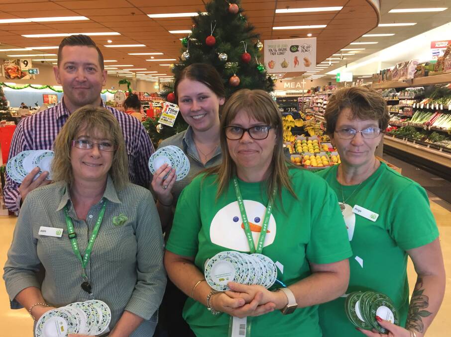 FRIENDLY TEAM: Woolworths Jimbooma manager Vladimir Galic and employees Sam Koop, Jamilee Rushbrook, Kylie Whyte and Ange Barby are spreading Christmas cheer. Photo: Tom Bushnell.