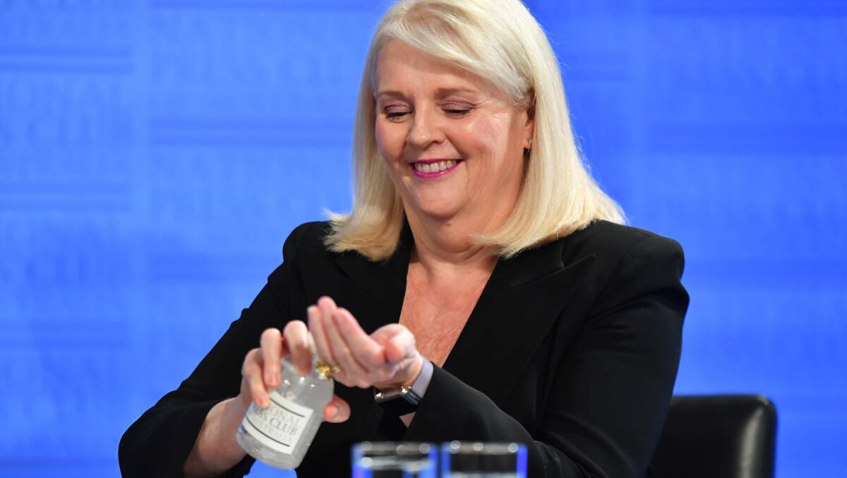 Industry Minister Karen Andrews applies hand sanitiser at the National Press Club on Wednesday. Ms Andrews said there were better ways to support the manufacturing industry than "throwing money" at research and development. Picture: AAP Images