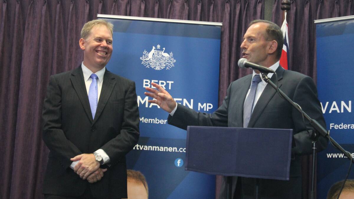 Mr Abbott, with Forde MP Bert van Manen, speaks to voters during a visit to the electorate in February.