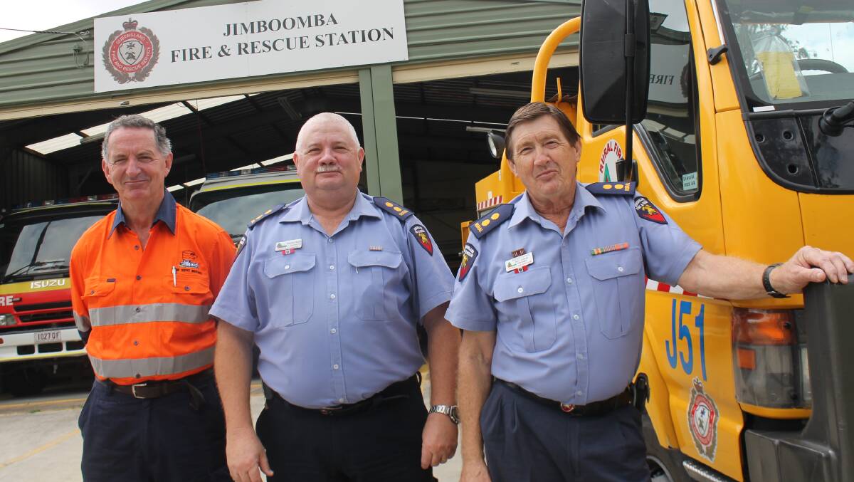 FIGHTING FIT: Jimboomba Rural Fire Brigade First Officer Bernie Savage (front) examines one of the station's upgraded trucks with Logan Beaudesert group officer David Heck and Pump Service Industries director Hugh McCabe.