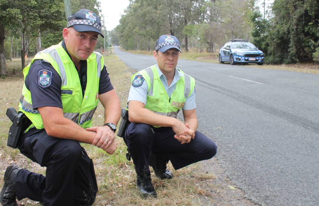 ON THE LOOKOUT: Jimboomba Police Senior Constable Ian Phillips and Acting Senior Sergeant Geoff Douglas examine a skid mark caused by hoons on Bluff Road in Cedar Vale.